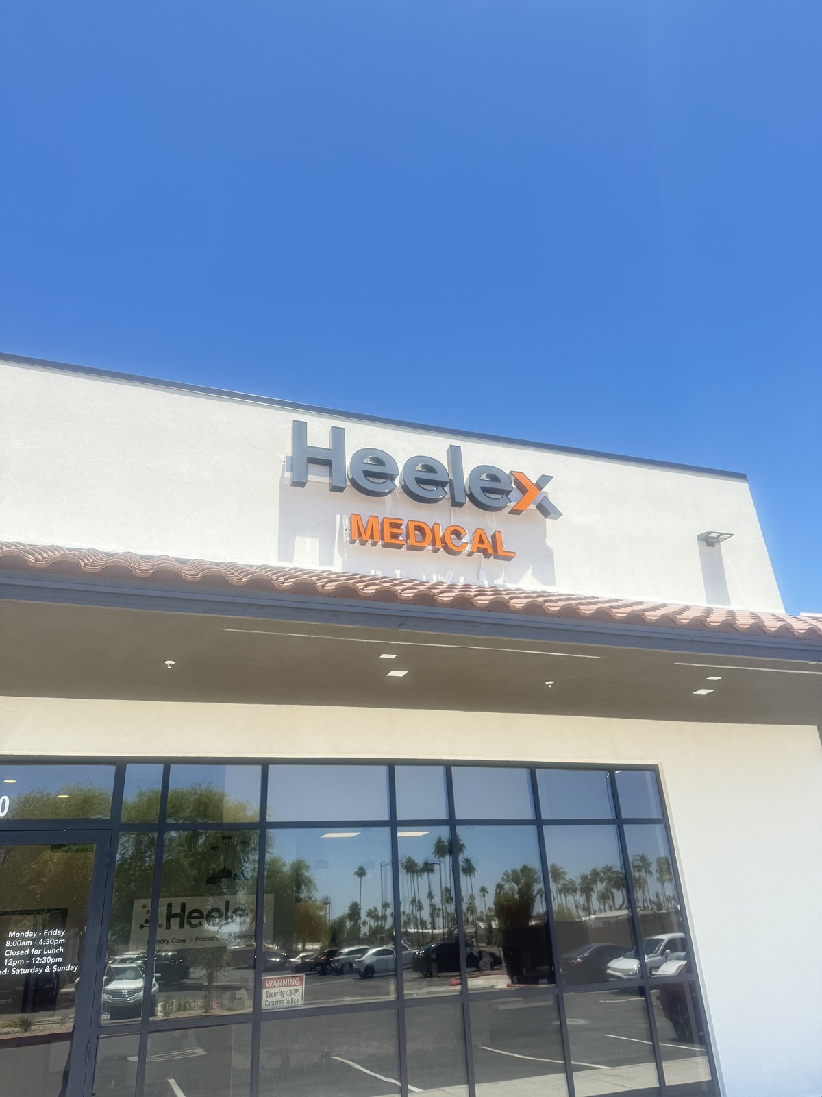Exterior of the Heelex Medical clinic in Knoxville, Tennessee, showing the orange and gray Heelex logo and main entrance.