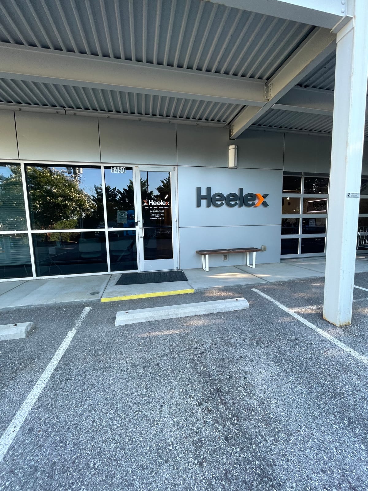 Close-up of the Heelex sign and glass entrance doors at the Knoxville clinic.