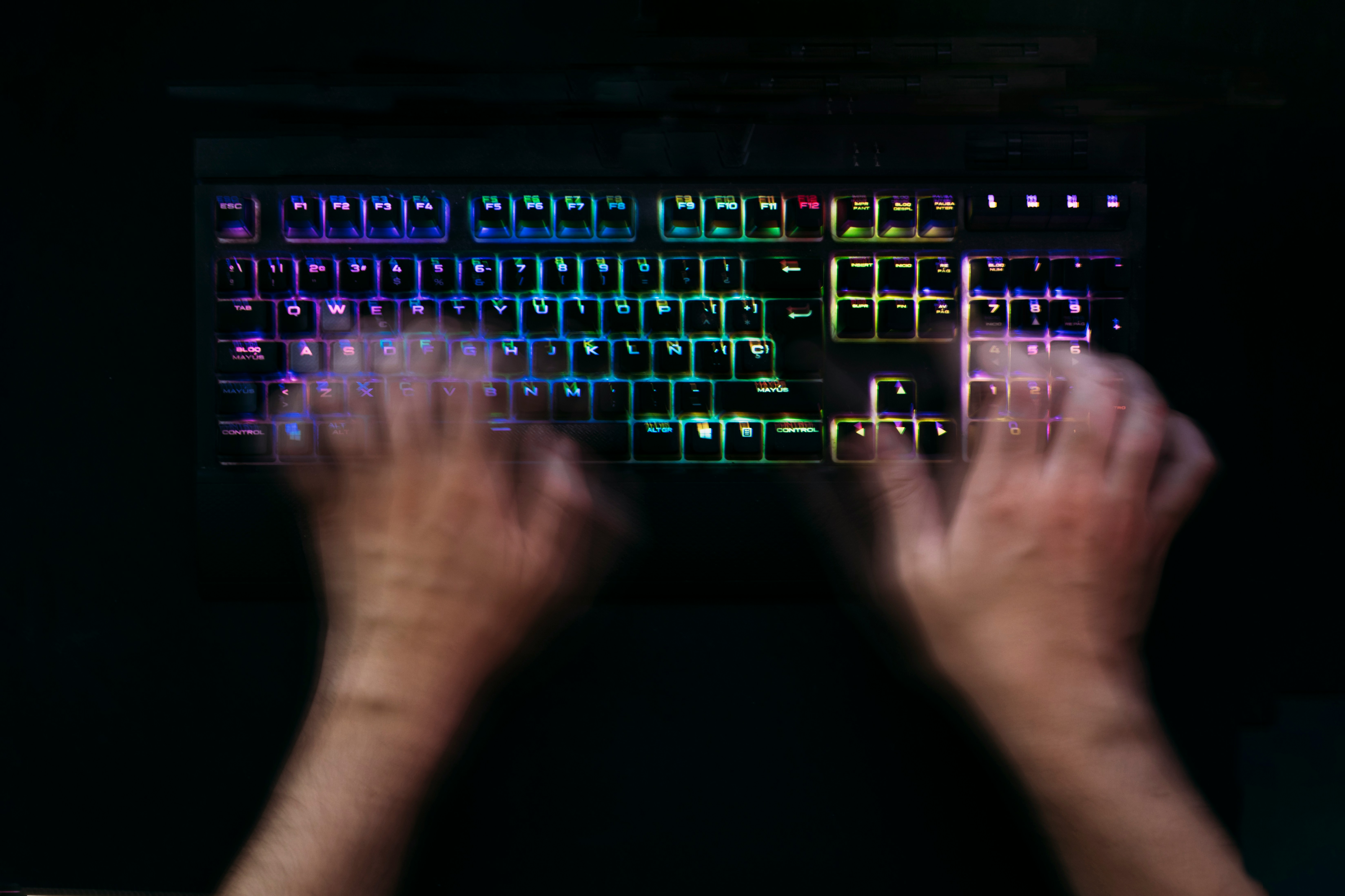 Hands at rest on a keyboard in warm light.